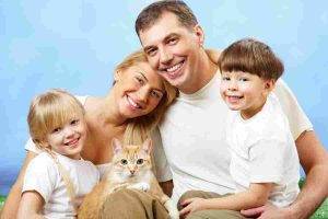 Happy family and their orange tabby cat