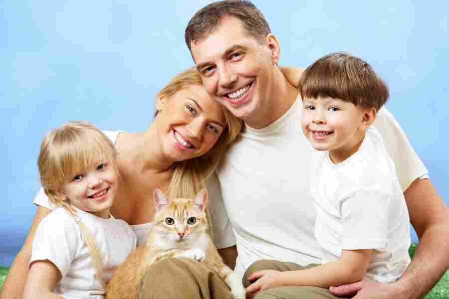 happy family and their orange tabby cat